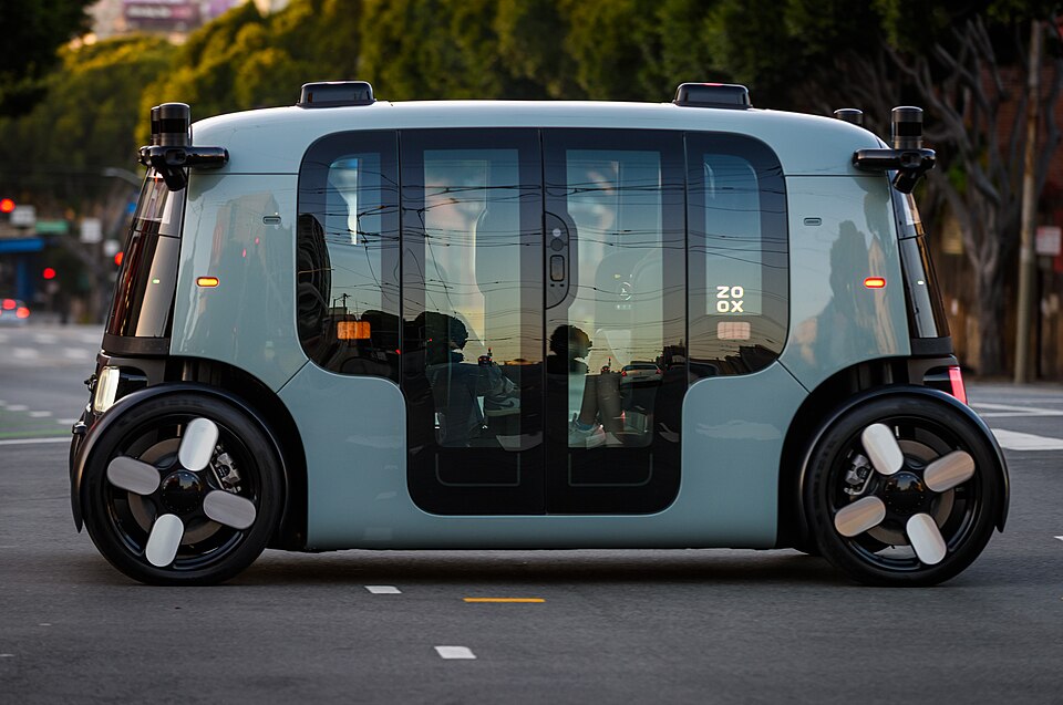 A Zoox robotaxi with passengers inside crossing Potrero Street in San Francisco, May 2025.